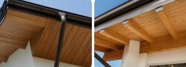 Detale drewnianej konstrukcji z brązową rynną na tle błękitnego nieba. Widoczne elementy mocujące i deski, tworzące zadaszenie. Ujęcie z dołu.