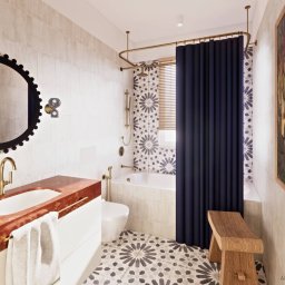 PROJEKTOWANIE WNĘTRZ Adrianna Lis - Nowoczesna łazienka z umywalką z czerwonego marmuru, okrągłym lustrem z czarną ramą i zasłoną prysznicową w kolorze granatowym. Na ścianie obraz w drewnianej ramie.