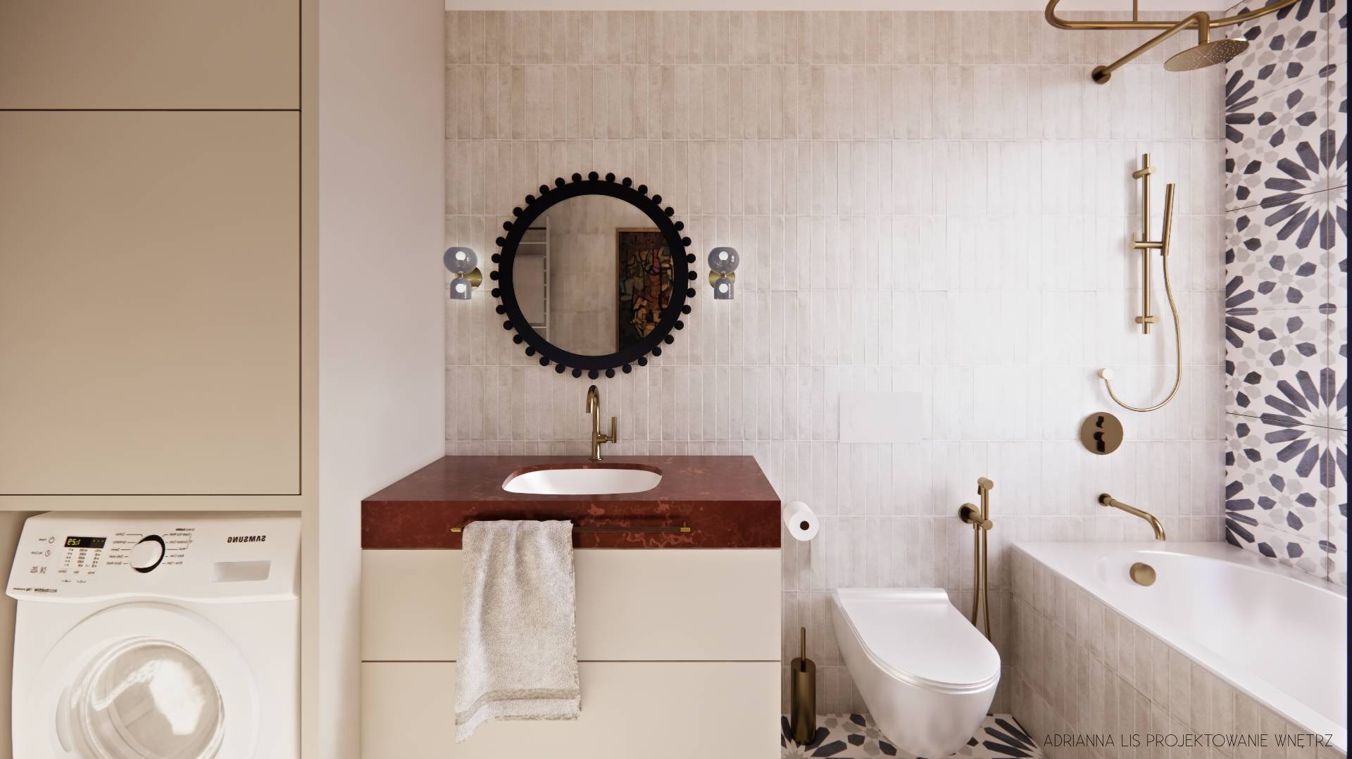 Nowoczesna łazienka z umywalką na blacie z terazzo, okrągłym lustrem z dekoracyjną ramą i złotą armaturą. Widoczna pralka i płytki w odcieniach beżu.