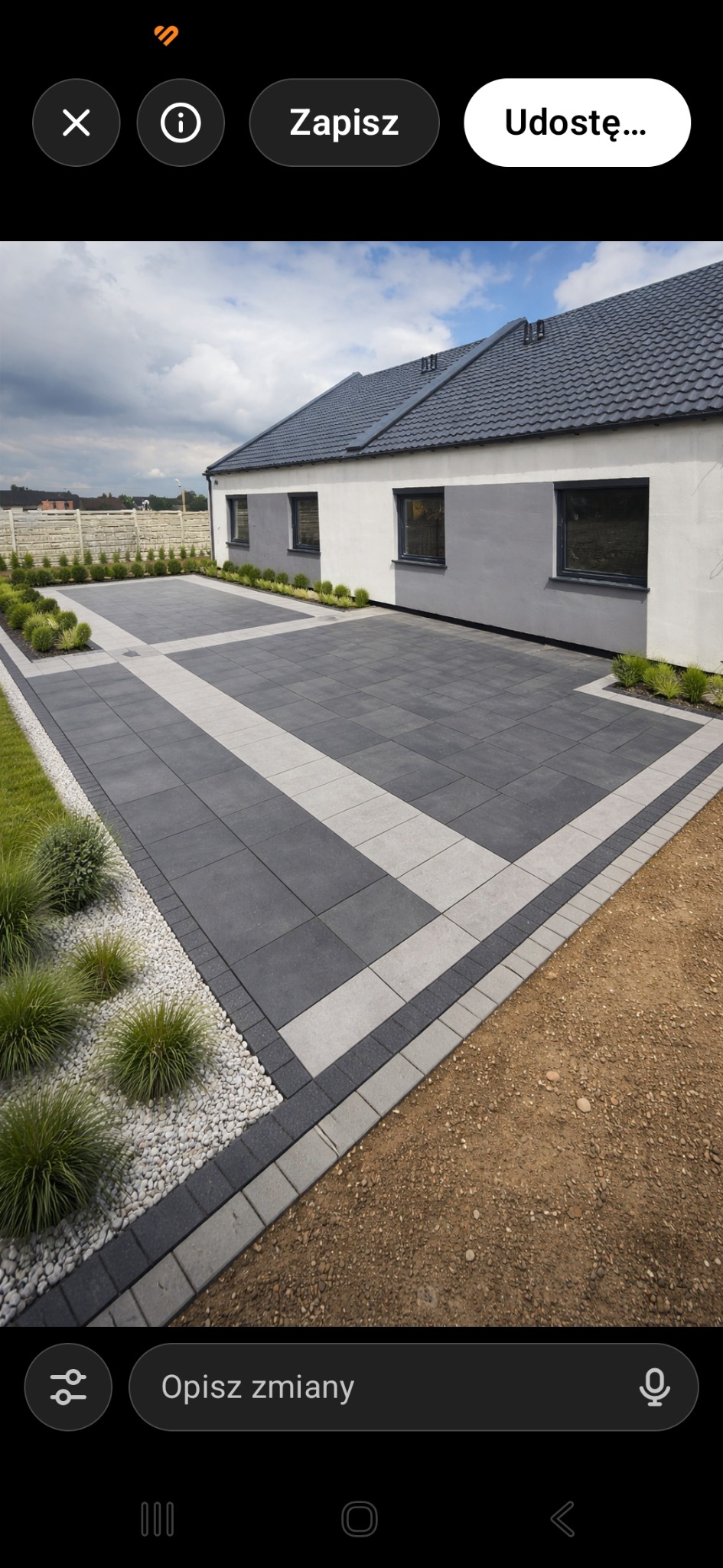 Nowoczesny podjazd z kostki betonowej w odcieniach szarości, z dekoracyjnymi pasami i obrzeżami. Widok na dom z szarą dachówką i starannie zagospodarowany ogród.