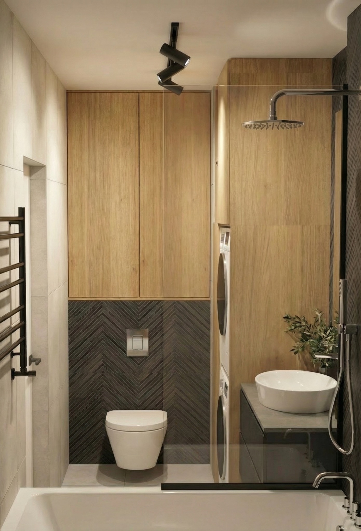 Nowoczesna łazienka z drewnianymi szafkami, szarą mozaiką w jodełkę, białą umywalką i pralką w zabudowie. Minimalistyczne oświetlenie punktowe.