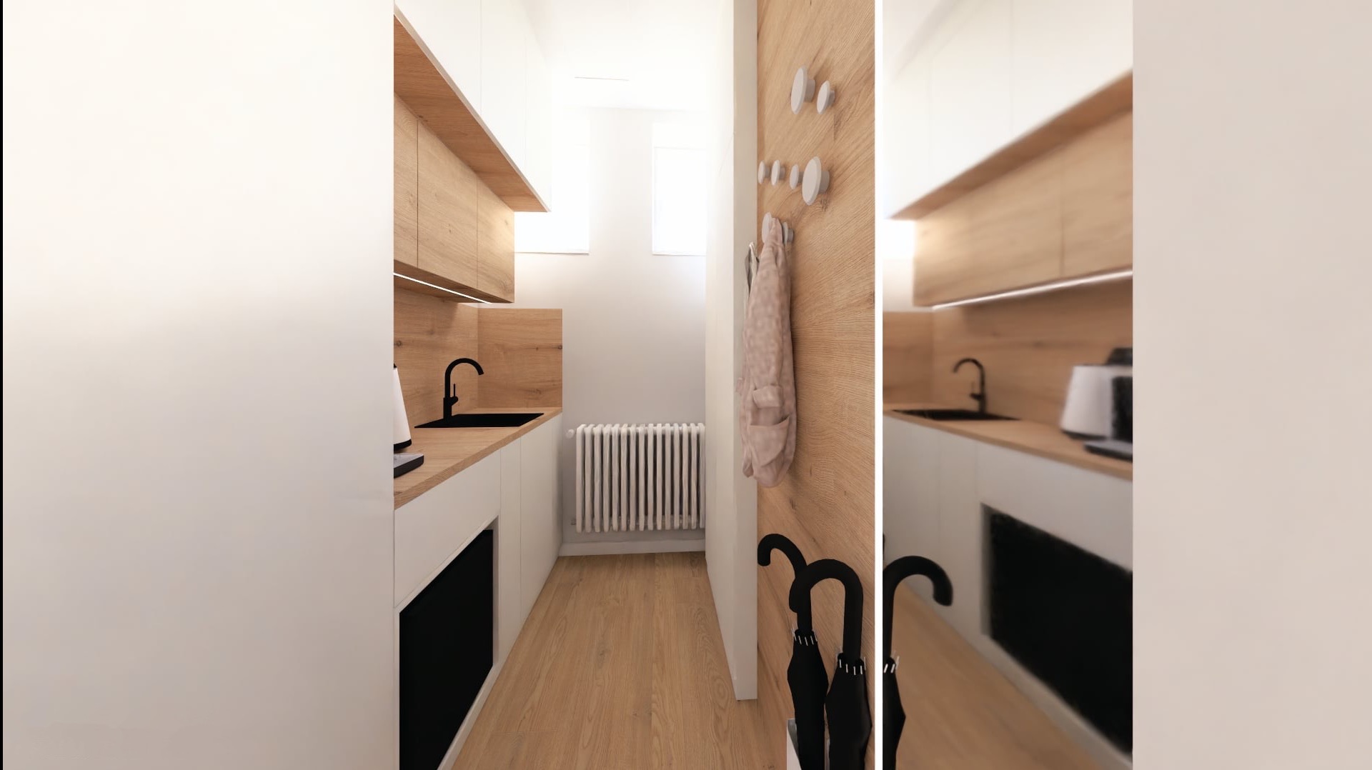 Wąska kuchnia z drewnianymi akcentami i białymi szafkami, czarny zlew i bateria, płaszcz i parasole przy wejściu, minimalistyczny design, jasne drewno na podłodze.