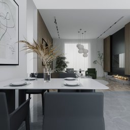 Jolanta Cioroch - Nowoczesna jadalnia z białym stołem, szarymi krzesłami i dekoracyjnym obrazem na ścianie. W tle salon z kominkiem i zielonym fotelem. Minimalistyczny design.