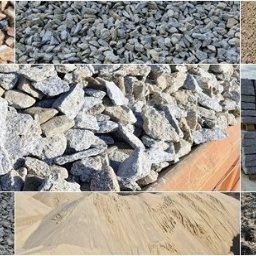 Rhino24 Group - Kompozycja z różnych materiałów budowlanych: żwir, piasek, kamienie, kostka granitowa ułożona na paletach. Różnorodność faktur i kolorów w jednym ujęciu.