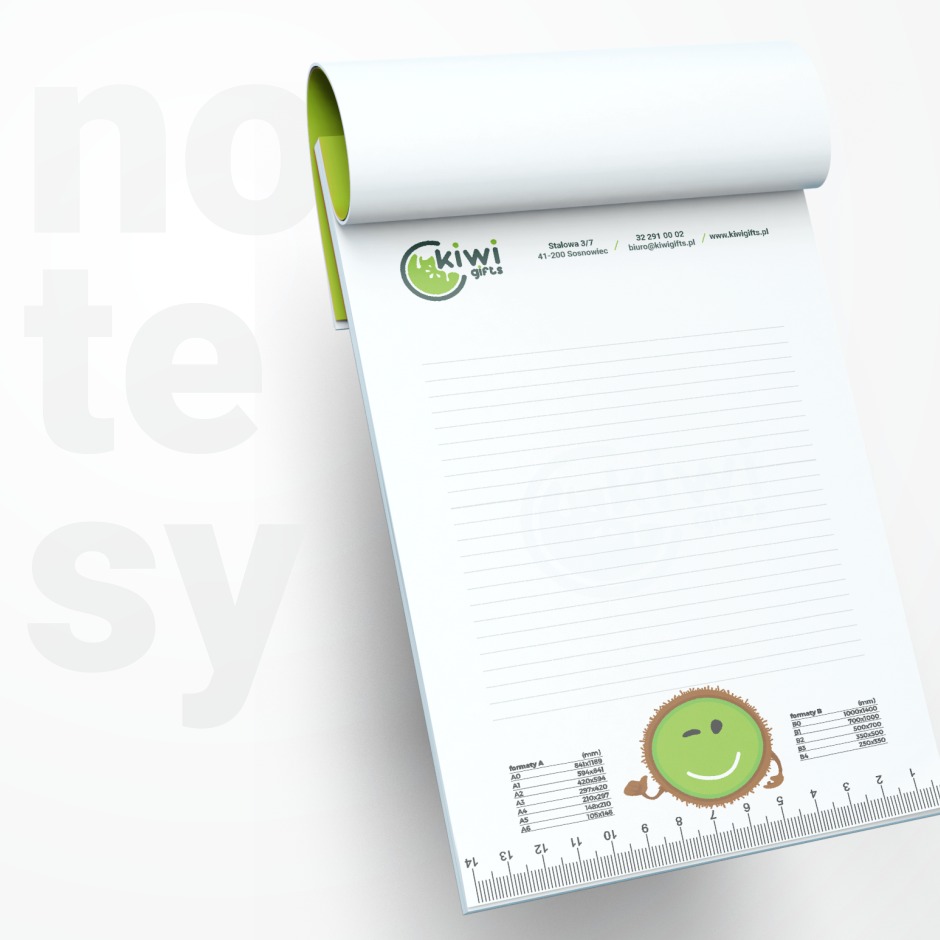 Blok biurowy z logo Kiwi Gifts, linijką na dole i tabelą formatów A i B, na białym tle z napisem 'notesy'.