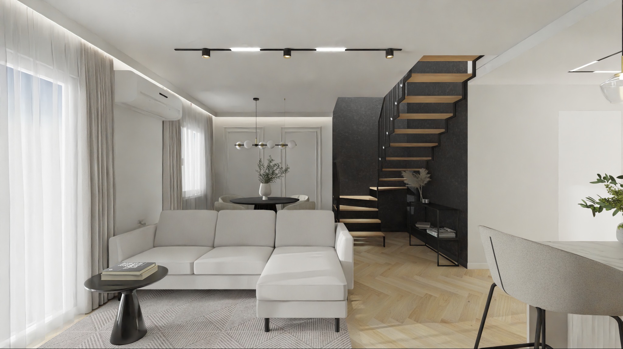 Nowoczesny salon z białą narożną sofą, czarnym stolikiem kawowym na jasnym dywanie. W tle jadalnia z okrągłym stołem i drewniane schody na ciemnej ścianie. Jasna podłoga w jodełkę.