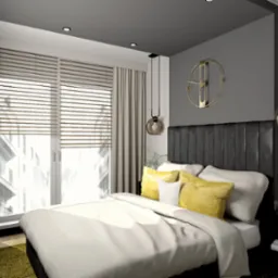 Sypialnia z łóżkiem z czarnym zagłówkiem, żółtymi poduszkami i okrągłym, złotym zegarem na szarej ścianie, oświetlona wiszącymi lampami z kulistymi kloszami.