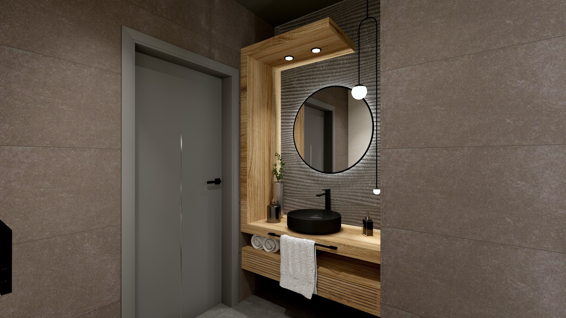 Nowoczesna łazienka z okrągłym lustrem podświetlanym LED, czarną umywalką nablatową i drewnianą szafką z ręcznikami, wykończona płytkami w odcieniach szarości.