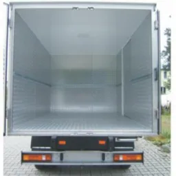 Pusta, czysta i oświetlona przestrzeń ładunkowa furgonetki z aluminiową podłogą i ścianami, widok od tyłu pojazdu.