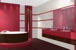 Wnętrze łazienki w odcieniach czerwieni i bieli: okrągła wanna z brązową obudową na podwyższeniu, umywalki nablatowe na czerwonej szafce, ściany z poziomymi pasami glazury i terakoty, oświetlenie...