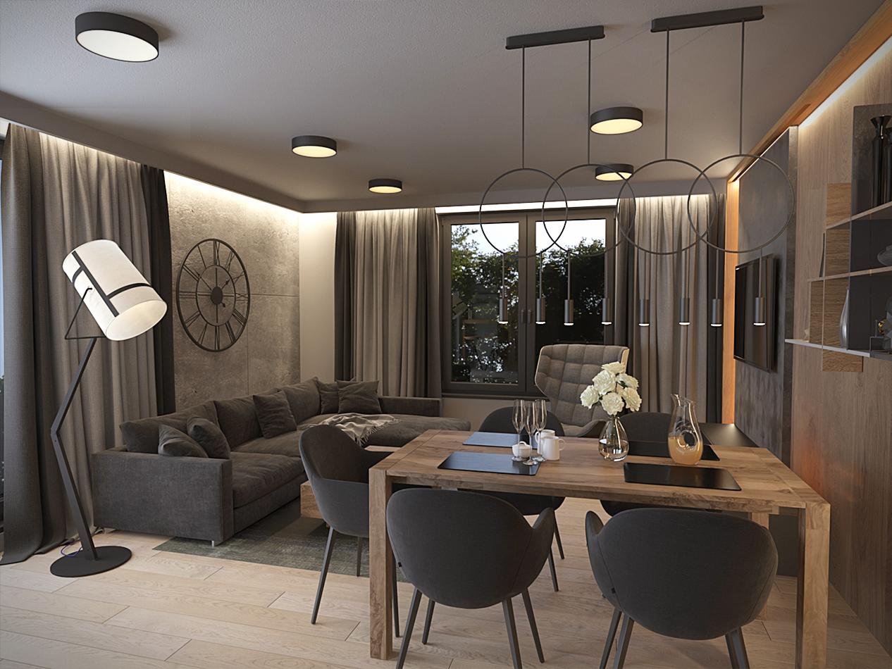 Nowoczesny salon z szarą sofą narożną, drewnianym stołem jadalnym i lampą podłogową w stylu reflektora. Na ścianie zegar w stylu industrialnym. Nad stołem wiszą lampy z okrągłymi elementami.