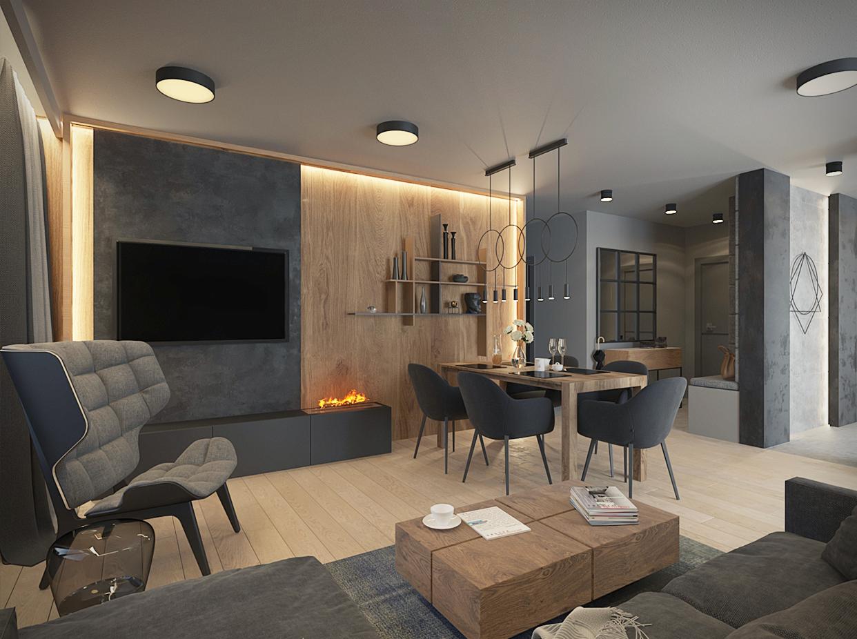 Nowoczesny salon z drewnianą ścianą akcentową, biokominkiem pod telewizorem i minimalistycznym oświetleniem, uzupełniony szarym fotelem z podnóżkiem i drewnianym stolikiem kawowym.