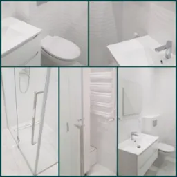 Nowoczesna łazienka w bieli: kabina prysznicowa ze szklanymi drzwiami, umywalka z szafką, toaleta, grzejnik drabinkowy i płytki imitujące fale.