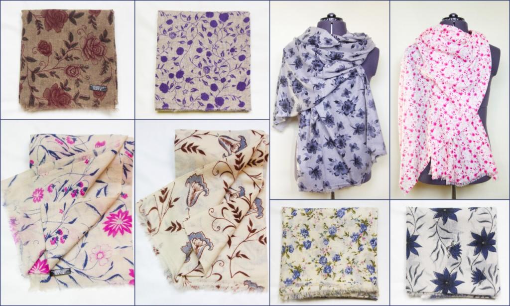 Kolekcja wzorzystych szali i chust: kwiatowe motywy w różnych kolorach, niektóre ułożone płasko, inne zaprezentowane na manekinach.