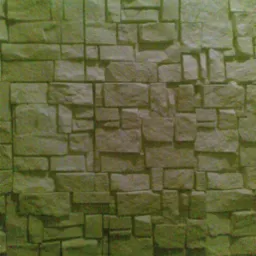 Elewacja z płytek kamiennych o nieregularnych kształtach i fakturze, imitująca mur z naturalnego kamienia.