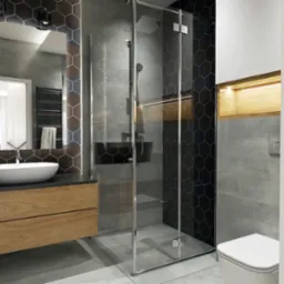 Nowoczesna łazienka z kabiną prysznicową ze szklanymi drzwiami, umywalką nablatową na drewnianej szafce, lustrem w ramie z heksagonalnych płytek oraz toaletą w tle.