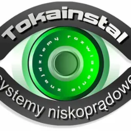 Logo firmy Tokainstal w kształcie oka z zieloną tęczówką i napisem 'systemy niskoprądowe' oraz 'rozwiązanie dla przemysłu'.